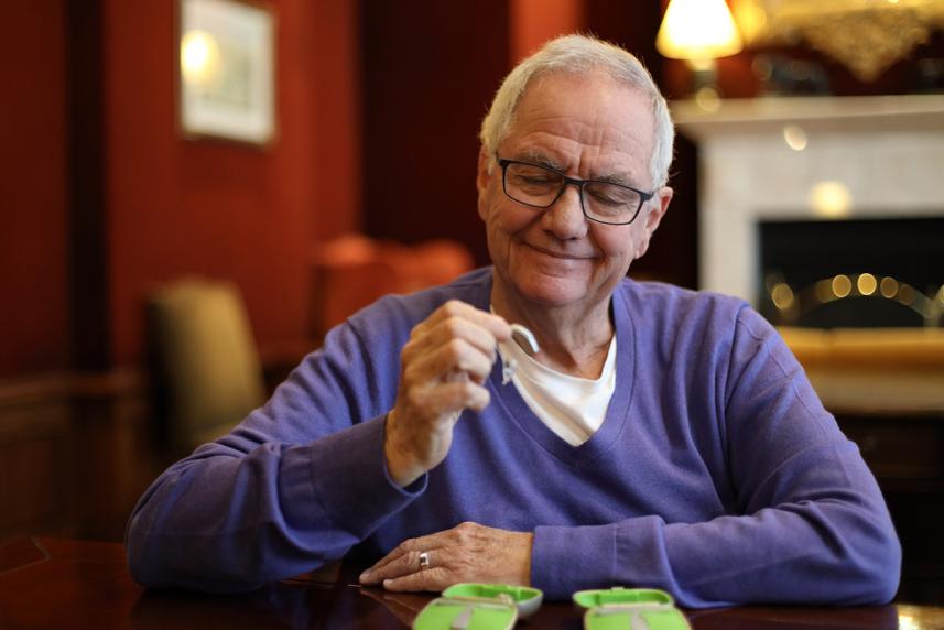A man holding a hearing aid