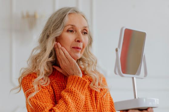 Woman looking at herself in the mirror